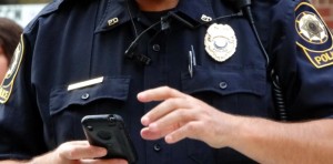 Officer holding cell phone