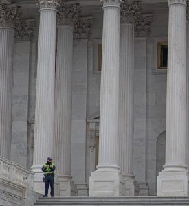 Officer-on-steps-of-DC-building-1-275x300